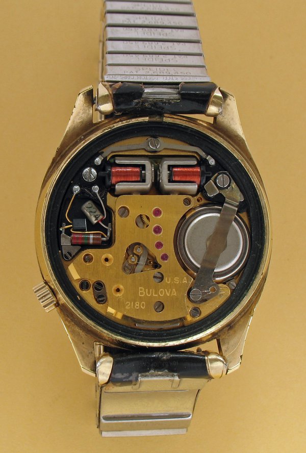 The movement of the Accutron watch.  The silver coloured cups, which surround the coils, form the tips of the tuning fork - motion blur can faintly be seen