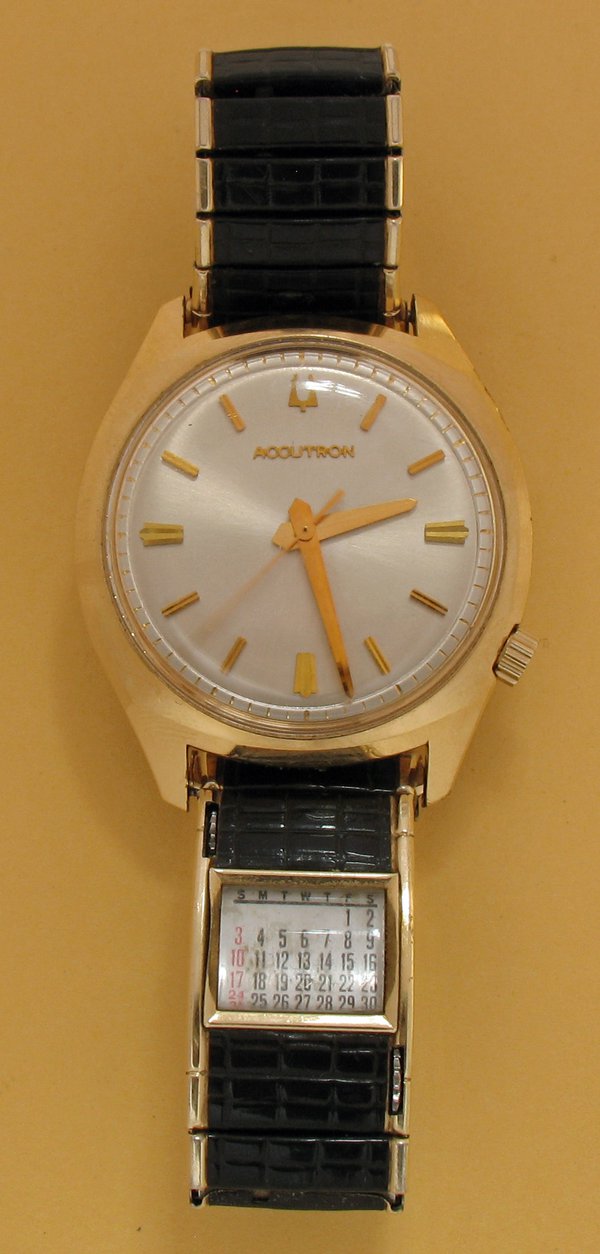 An ‘Accutron’ tuning-fork watch, made by Bulova, USA, c.1970.  The one second exposure of the photgraph reveals the near sweep action of the seconds hand.  Note also the useful perpetual roller calendar in the strap (inscribed "SPEIDEL PAT 2,689,450").