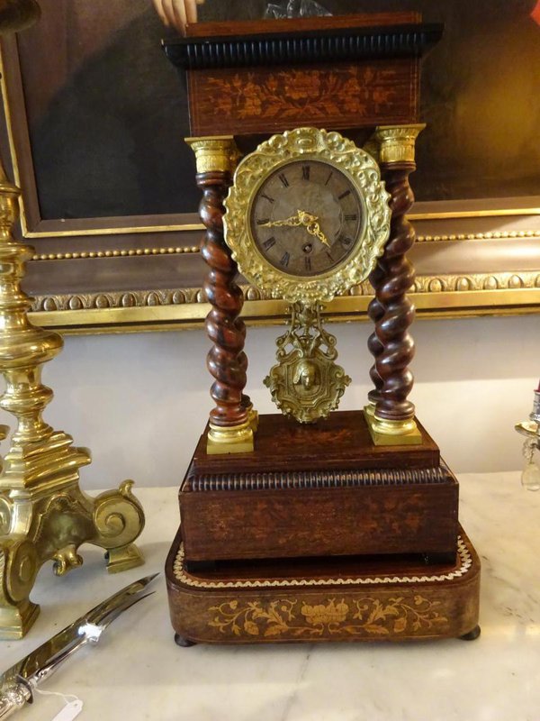 The clock without its glass dome but with its gilt pendulum