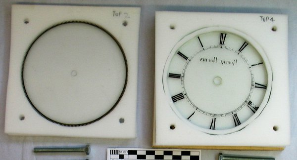 Glass disc and dial in a special carrier prior to cleaning by Ceramics Students. The Indian Ink marking on glass was fragile