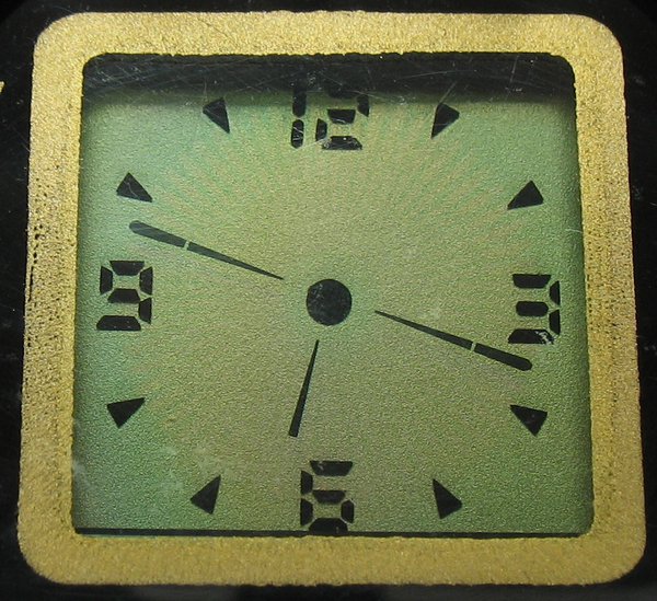 Close-up of the dial.  The time shown here is .  Despite the seconds and minute hands appearing identical in this still, the seconds are readily visible when reading the time