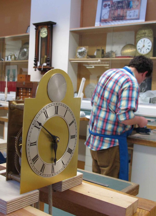 Three-wheel-train-clock-hand-made-by-every-new-student.